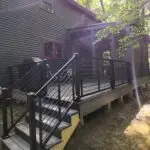 Here’s a screen porch that combines rugged durability with refined style, featuring an open timber design and a sleek metal roof. The timber beams echo the strength of New Hampshire’s timber frame barns, which have stood the test of time for centuries. The aluminum horizontal railing is a modern touch that contrasts beautifully with the natural wood, offering a clean, contemporary line. Think of this porch as a modern take on the classic porches of rural New Hampshire, where families would sit in the evening and enjoy the cool mountain air after a long day on the farm. Just like the old porches of the White Mountains, this space blends the beauty of nature with practical design, creating a perfect retreat to watch the sun dip behind the hills.