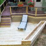 Here’s a deck with character—a wraparound composite deck that steps down into another level, with a planter adding a touch of green right to the heart of your outdoor space. It’s got the flow and beauty of the old New England porches that used to greet visitors as they made their way to the farmhouse in the rolling hills of New Hampshire. Whether you’re enjoying a quiet evening or hosting a family gathering, this deck offers the perfect combination of beauty and function, just like those old country homes in places like Walpole that have stood the test of time. It’s a space to entertain, relax, and make memories.