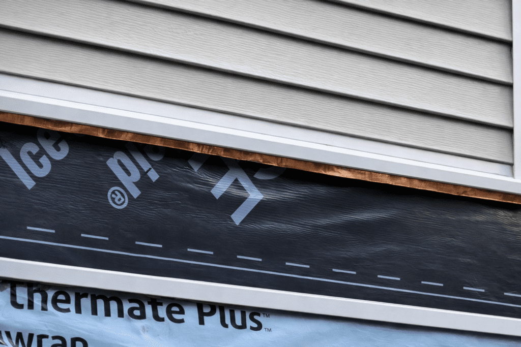 Deck flashing and siding detail installed for long-term weather protection in central New Hampshire