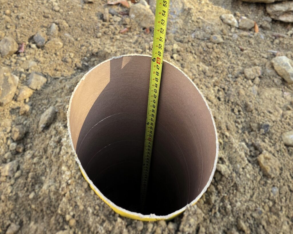 Deck footing formed below frost depth for long-term stability in central New Hampshire